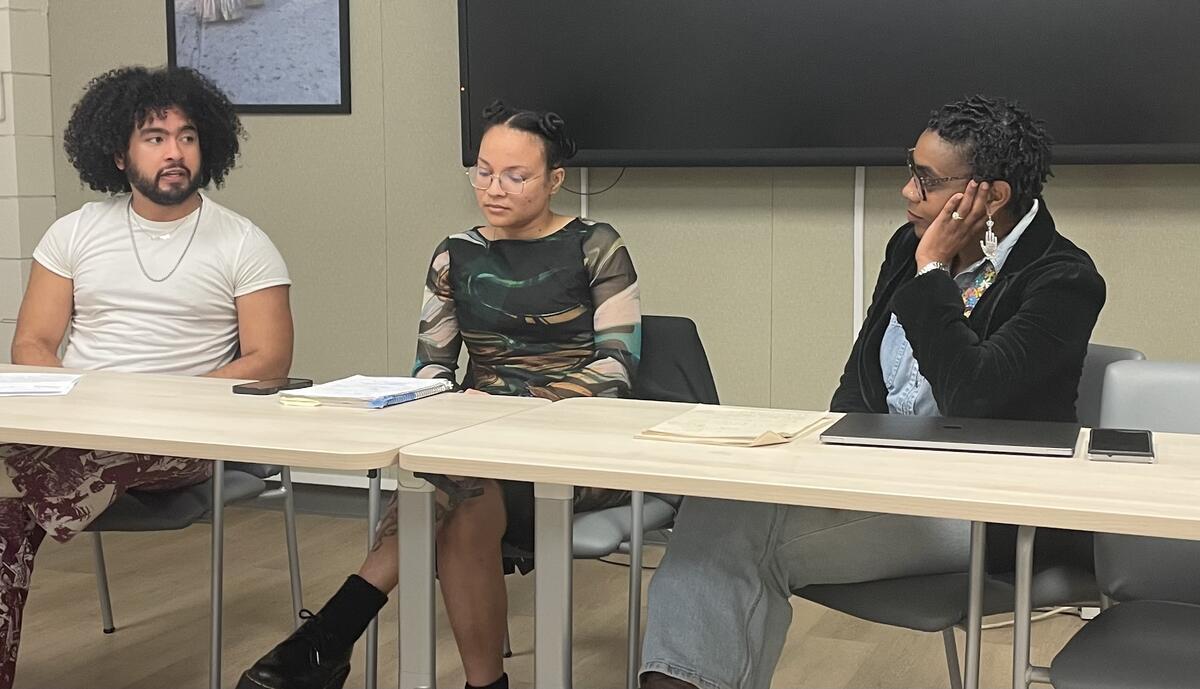 A phot of three people at a table