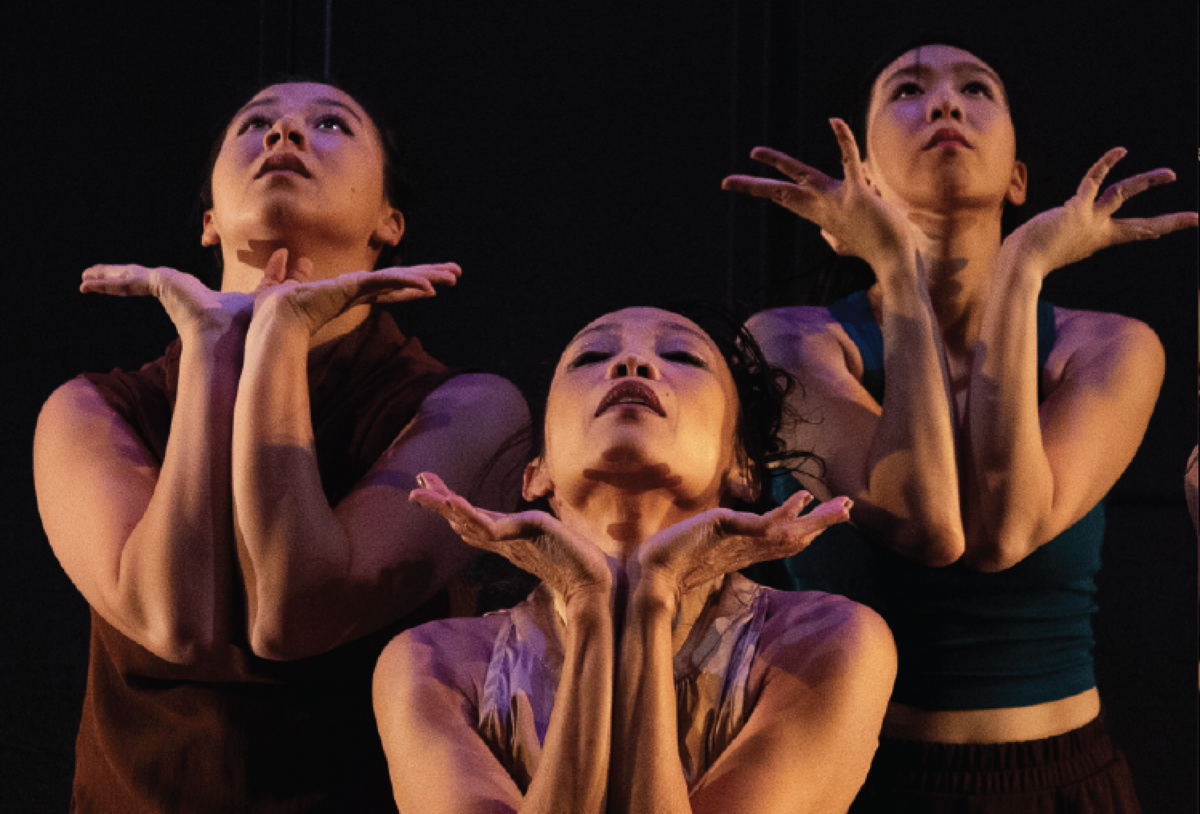 A photo of three Asian American women dancing