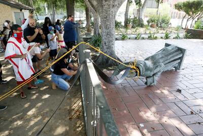 Activists topple the statue of Father Junipero Serra in El Pueblo de Los Angeles in Olvera Street.