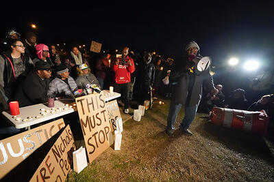 Rev. Andre E Johnson, of the Gifts of Life Ministries, preaches at a candlelight vigil for Tyre Nichols, who died after being beaten by Memphis police officers, in Memphis, Tenn., Jan. 26, 2023. Behind him, seated center, are Tyre’s mother and stepfather.